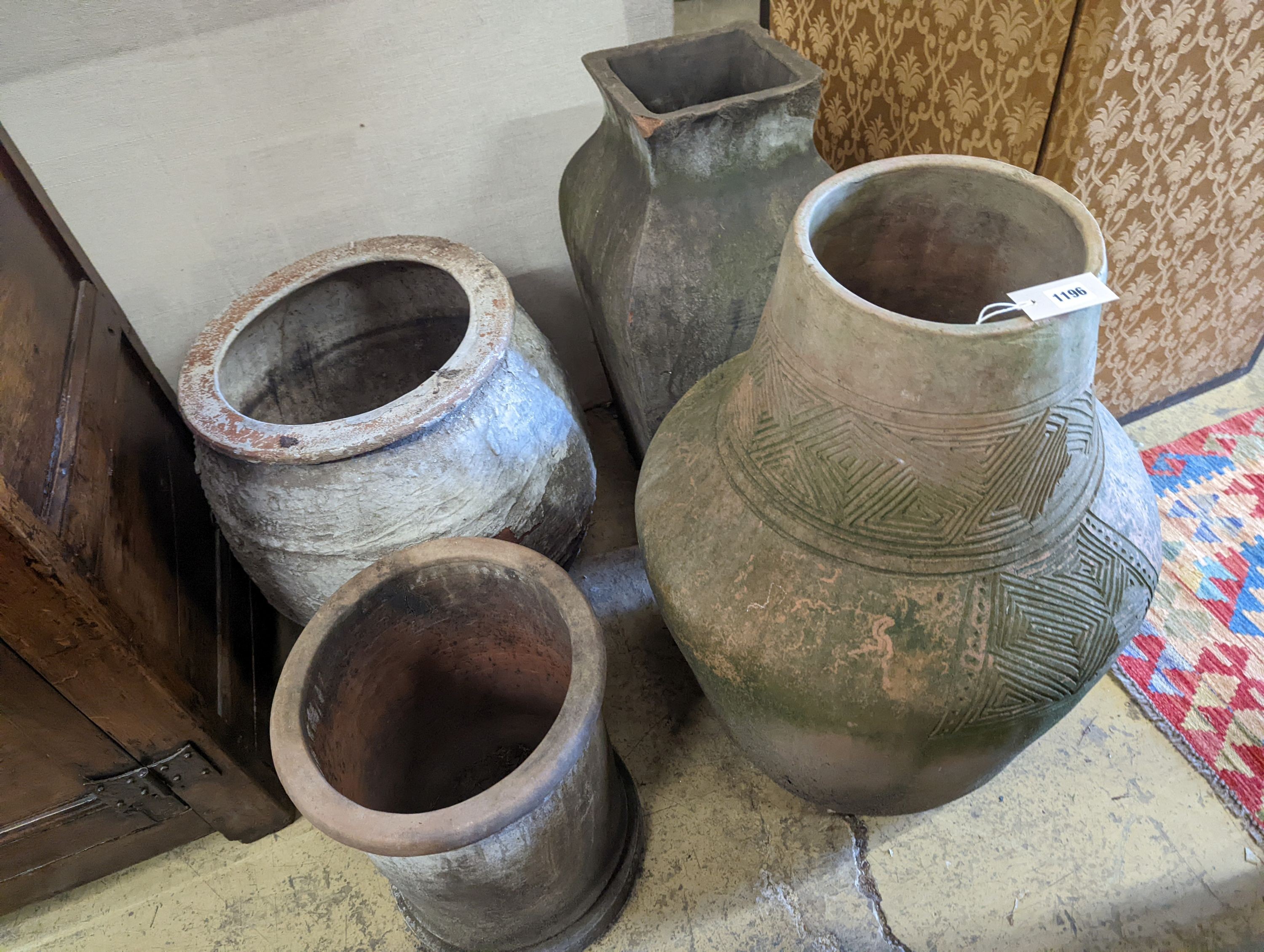 A large incised terracotta garden urn, height 72cm together with three other large earthenware garden urns